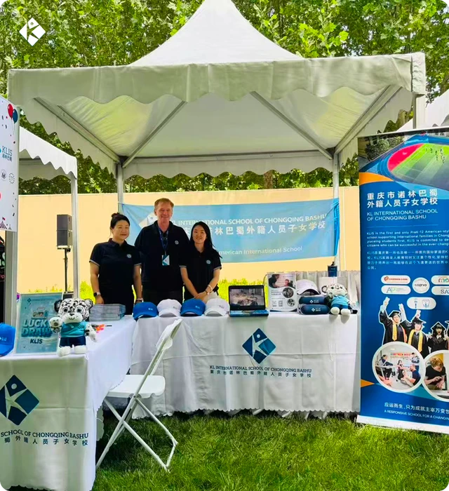 KLIS booth at the American Citizens Fair with branded souvenirs and school display boards