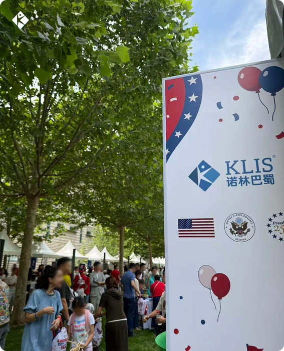 KLIS signage with the U.S. flag and embassy decorations at the outdoor American Citizens Fair