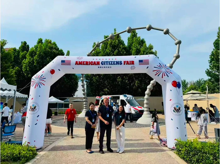 KLIS staff pose under the American Citizens Fair archway at the U.S. Embassy in Beijing