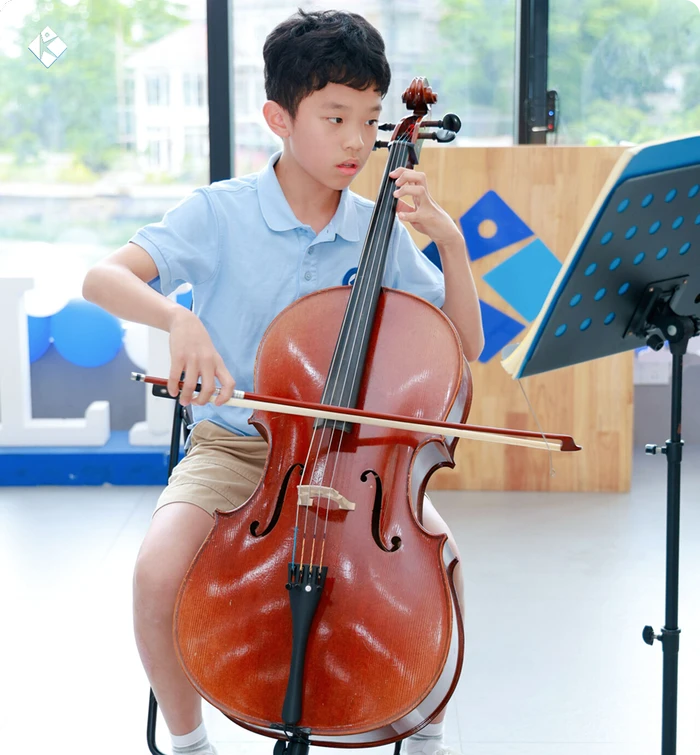 KLIS student performing the cello at the school Music & Art Festival