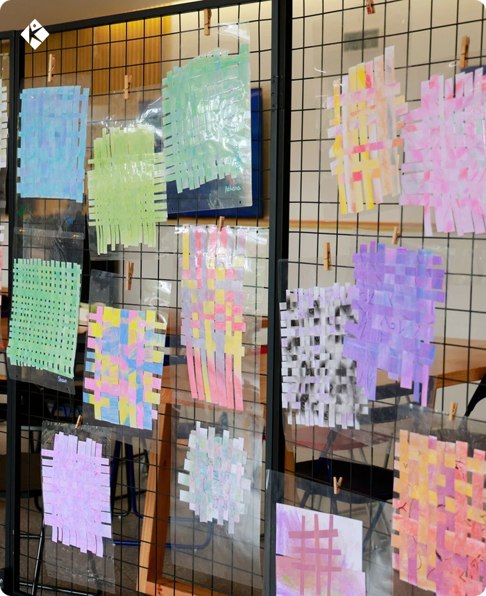 Colorful woven paper crafts created by KLIS students for the art exhibition