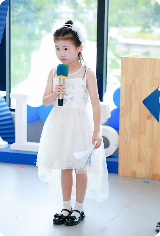 KLIS student in a princess dress hosting the Music & Art Festival