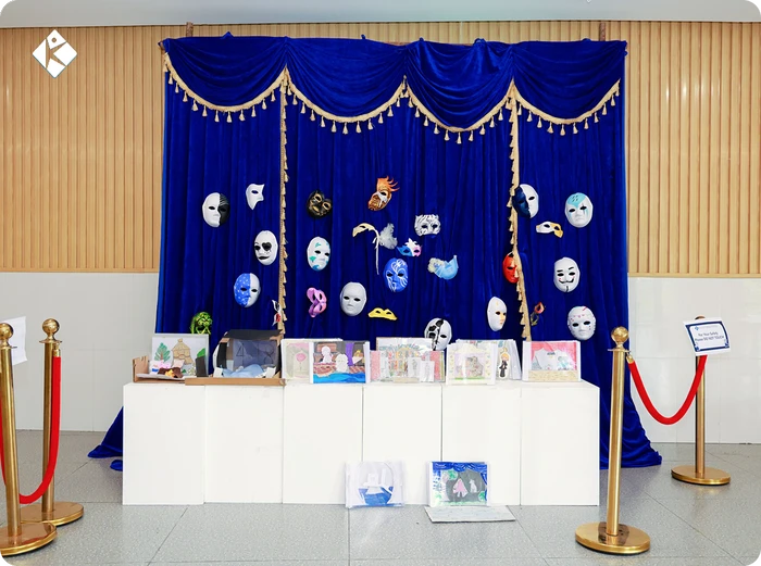 Handmade masks and student paintings displayed at the KLIS art exhibition