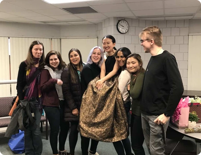 Sasha with music students after recital in university music department lounge